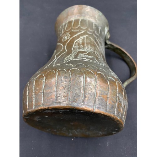 796 - Middle Eastern hand beaten silvered copper drinking vessel of crude design.