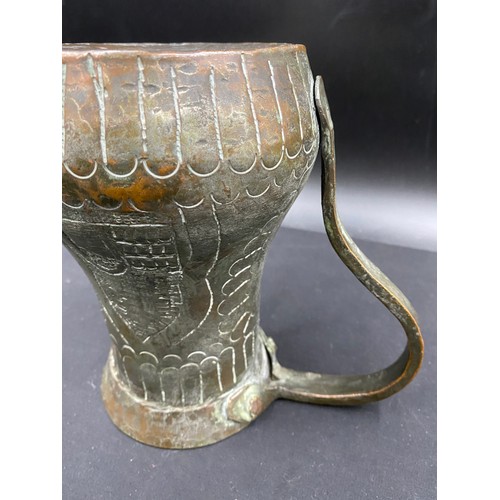 796 - Middle Eastern hand beaten silvered copper drinking vessel of crude design.