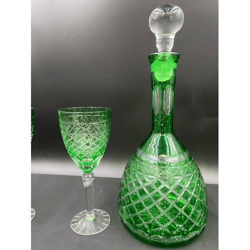 310 - A 20thC green and clear cut glass set comprising a decanter 35cm h and 5 x wine glasses 20cm h.