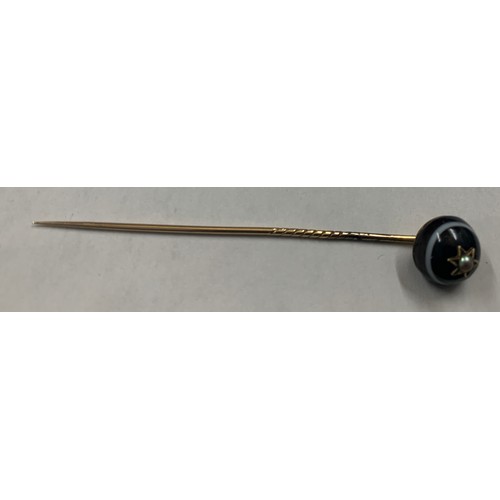 353 - Banded agate and seed pearl mourning stick pin set on yellow metal.