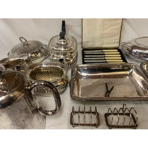 524 - A quantity of silver-plate to include tea service, toast racks, entrée dishes etc.