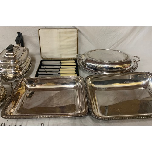 524 - A quantity of silver-plate to include tea service, toast racks, entrée dishes etc.