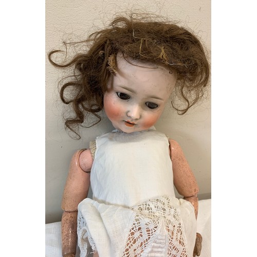 713 - Schoenau and Hoffmeister 1909 bisque headed doll with brown sleeping eyes and open mouth.  60cm h.