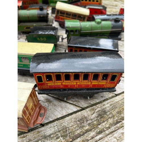 715 - A collection of Tin Plate railway items including trains, carriages/wagons etc.