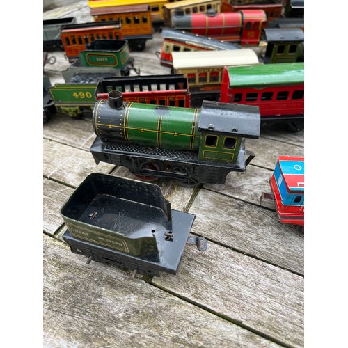 715 - A collection of Tin Plate railway items including trains, carriages/wagons etc.