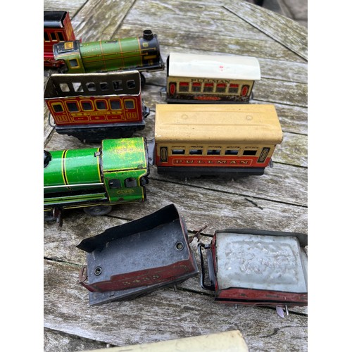 715 - A collection of Tin Plate railway items including trains, carriages/wagons etc.