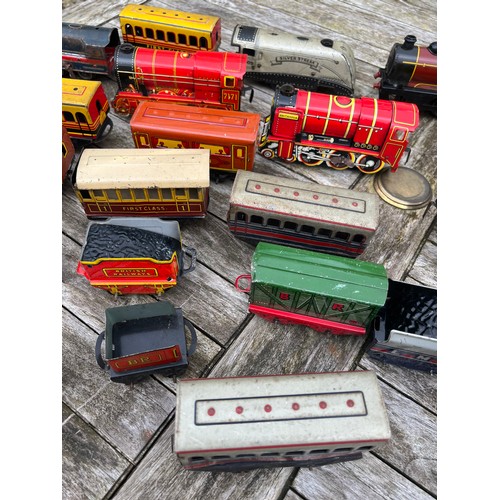 718 - A collection of vintage tinplate Clockwork trains and carriages etc.