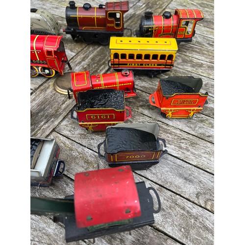 718 - A collection of vintage tinplate Clockwork trains and carriages etc.