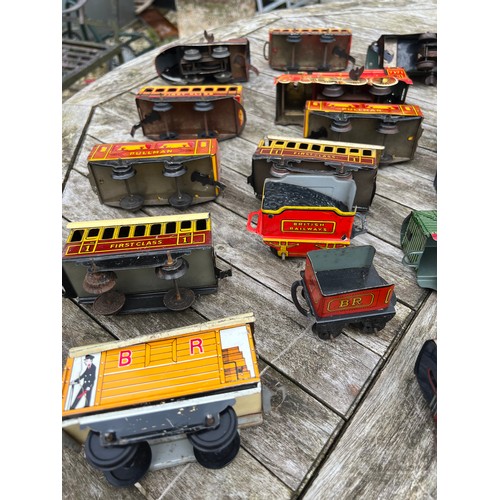 718 - A collection of vintage tinplate Clockwork trains and carriages etc.