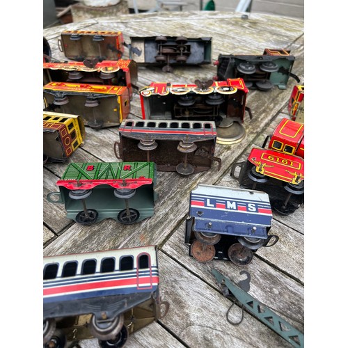 718 - A collection of vintage tinplate Clockwork trains and carriages etc.