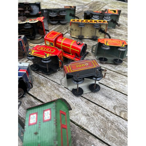 718 - A collection of vintage tinplate Clockwork trains and carriages etc.