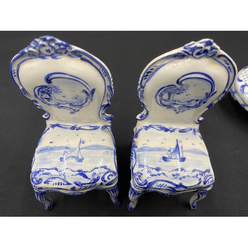 90 - Continental porcelain miniature blue and white furniture. Two small tables with marks to base.