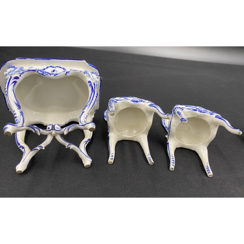 90 - Continental porcelain miniature blue and white furniture. Two small tables with marks to base.