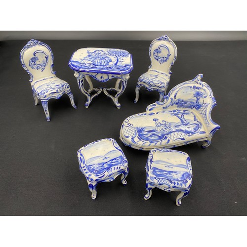 90 - Continental porcelain miniature blue and white furniture. Two small tables with marks to base.