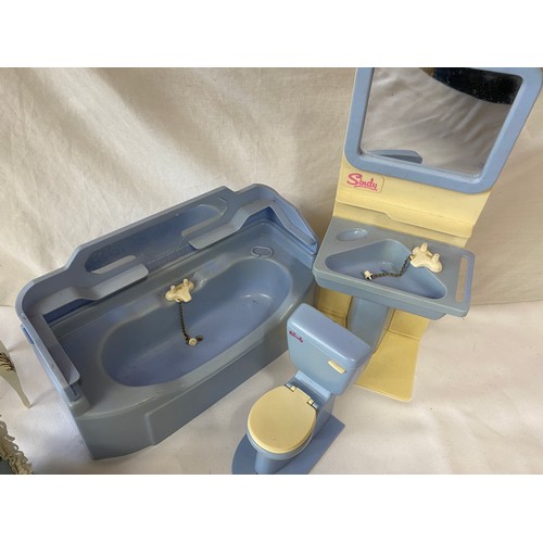 737 - A Sindy bathroom suite comprising bath, sink and loo  together with a bedroom chair and a dressing t... 