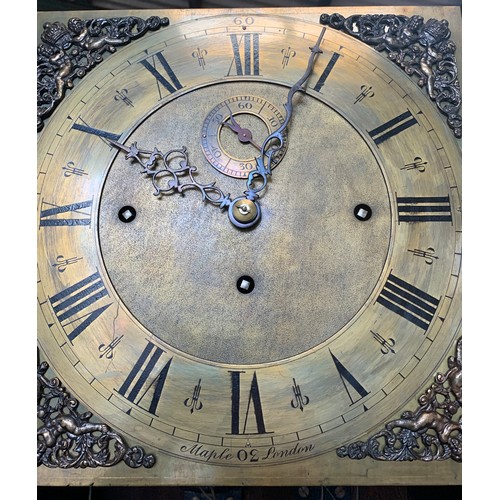 838 - A Maple of London carved oak longcase clock, with three train movement and Westminster chime.