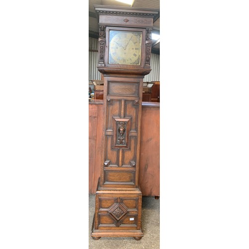 838 - A Maple of London carved oak longcase clock, with three train movement and Westminster chime.