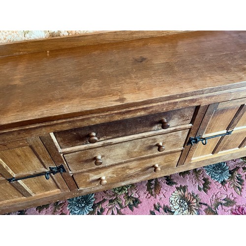 785B - Peter Heap Rabbitman, An Oak Panelled Sideboard, with raised upstand above two cupboard doors enclos... 