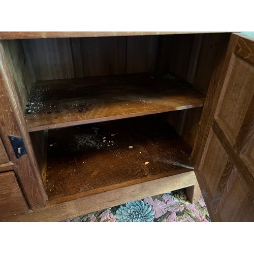 785B - Peter Heap Rabbitman, An Oak Panelled Sideboard, with raised upstand above two cupboard doors enclos... 