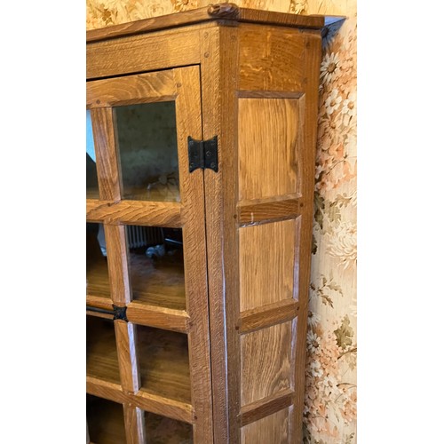 785 - Peter Heap Rabbitman , an oak standing corner cupboard, panelled with a glazed door over a panelled ... 