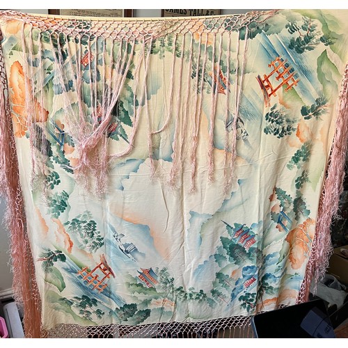 500 - A Chinese silk shawl depicting pagodas and landscapes. 124cm square excluding tassels.