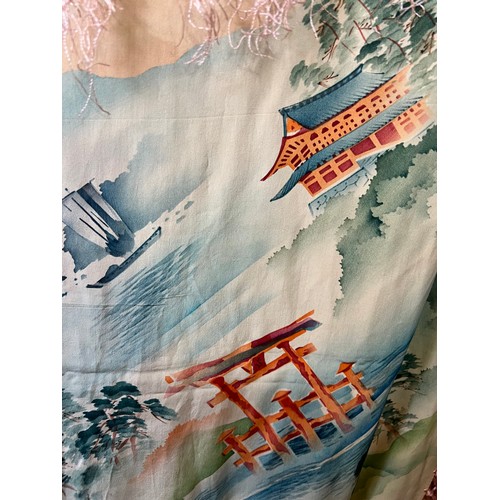 500 - A Chinese silk shawl depicting pagodas and landscapes. 124cm square excluding tassels.