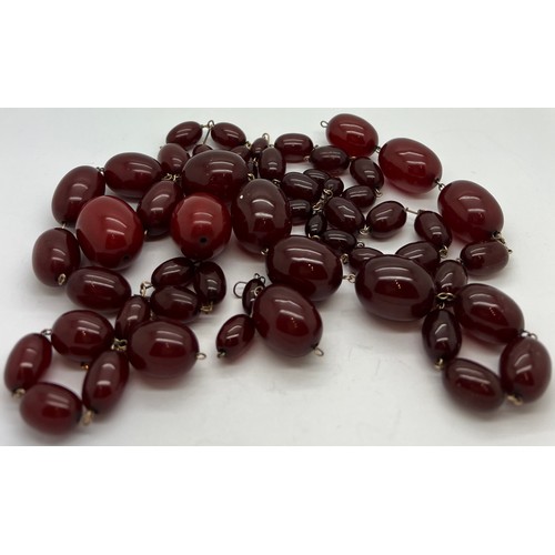 378 - A quantity of cherry amber beads to include 2 necklaces and other loose beads. 164gm total weight.