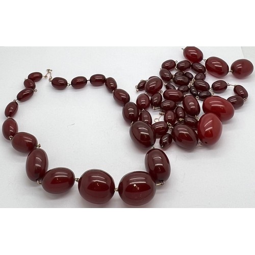 378 - A quantity of cherry amber beads to include 2 necklaces and other loose beads. 164gm total weight.