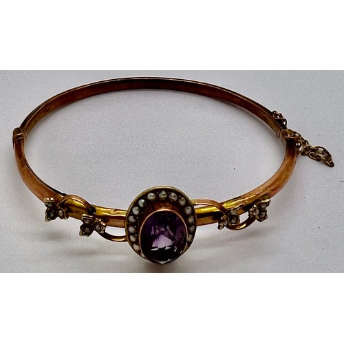 380 - Edwardian 9ct gold bangle with amethyst and seed pearls. 7gm.