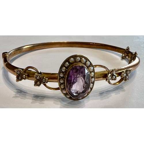 380 - Edwardian 9ct gold bangle with amethyst and seed pearls. 7gm.