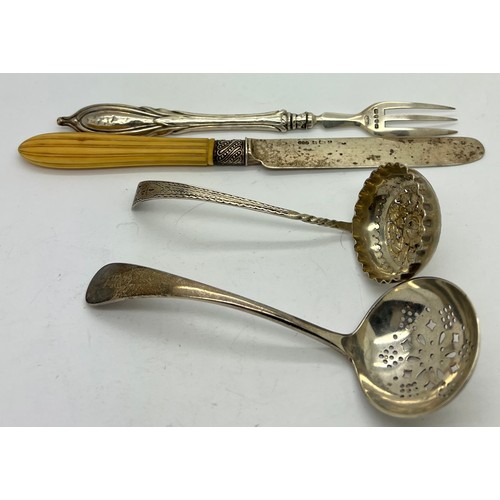 570 - Silver to include; two sifter spoons, silver bladed knife and a fork, sifter with bright cut decorat... 