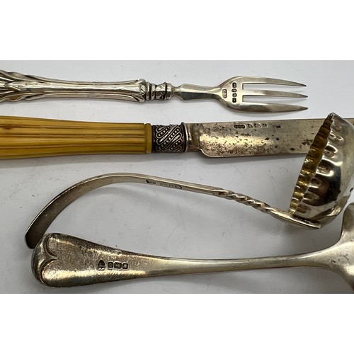 570 - Silver to include; two sifter spoons, silver bladed knife and a fork, sifter with bright cut decorat... 