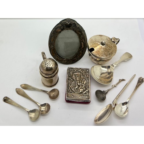 572 - A quantity of silver to include caddy, salt and mustard spoons, mustard pot, pepper pot, oval frame ... 