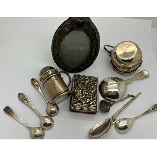 572 - A quantity of silver to include caddy, salt and mustard spoons, mustard pot, pepper pot, oval frame ... 