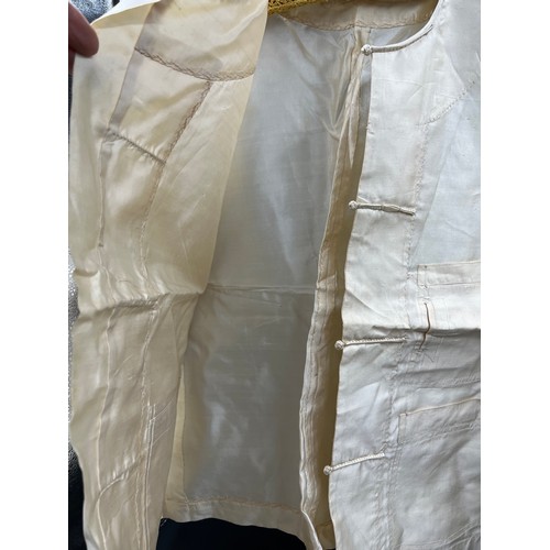 503 - A Chinese cream silk jacket with pockets, labelled Sein Bros together with a bone and silk fan 33 cm... 