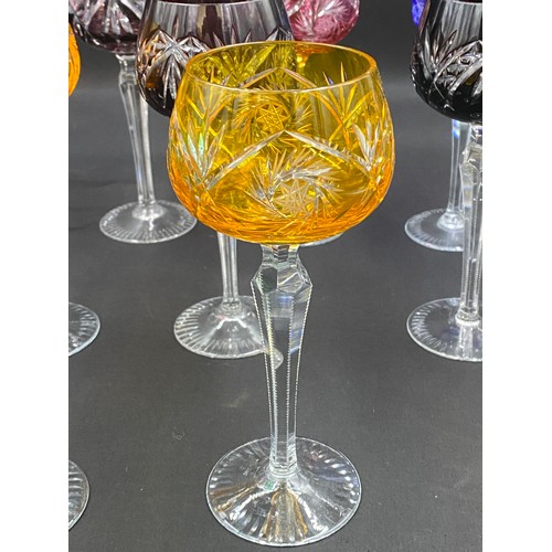 318 - Ten coloured glass hock glasses with faceted stems. 20cm h.