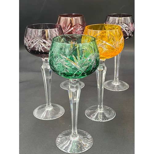 318 - Ten coloured glass hock glasses with faceted stems. 20cm h.