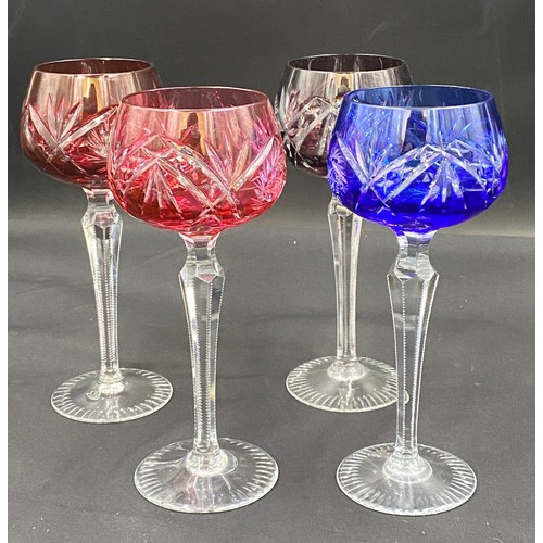 318 - Ten coloured glass hock glasses with faceted stems. 20cm h.