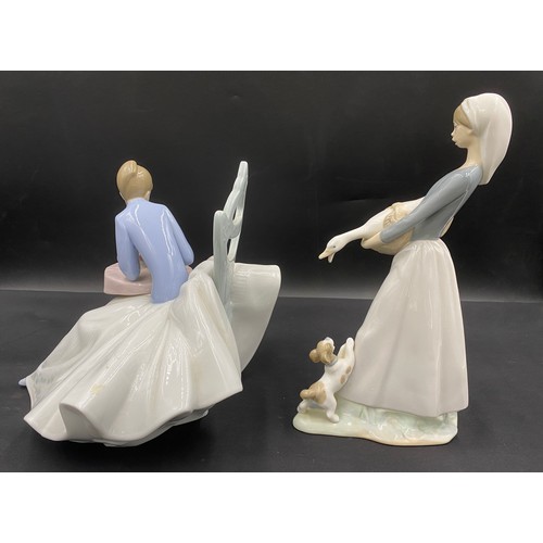 144 - Two figurines to include Lladro Daisa and NAO figurine, playing with kitty 1355. Tallest 27cm h.