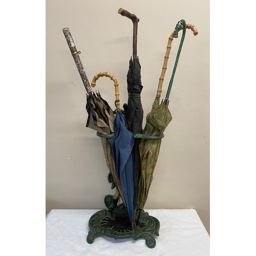 1054 - A cast iron painted umbrella/stick stand. With figure of gentleman to centre. 55cm  h x 31cm w.