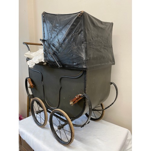 1057 - A vintage dolls pram.