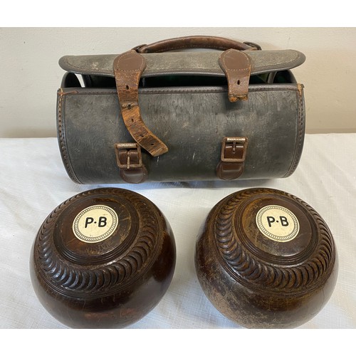 1058 - Taylor bowling balls with initials P.B to each and inscribed Watson. With case.