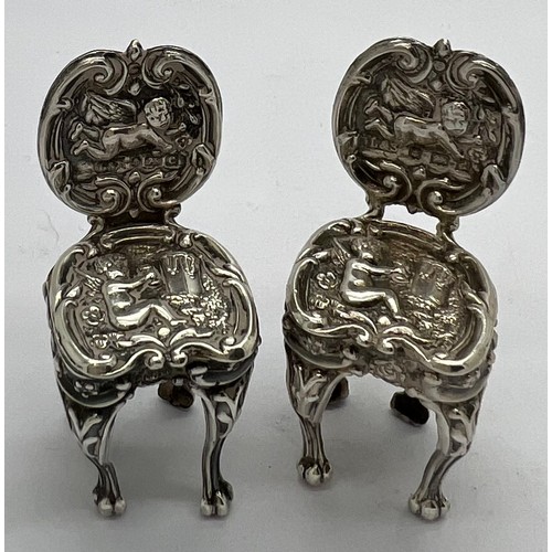 580 - A pair of miniature silver chairs. Birmingham 1902, maker Levi & Salaman. 4cm h.