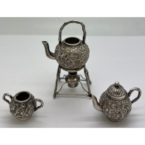 591 - Miniature Chinese silver teapot, kettle on stand and sugar bowl with prunus blossom decoration marke... 