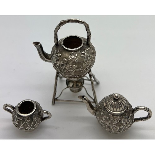 591 - Miniature Chinese silver teapot, kettle on stand and sugar bowl with prunus blossom decoration marke... 