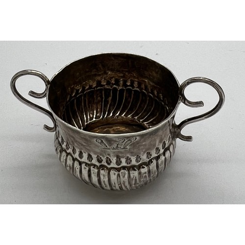 592 - A Queen Anne miniature porringer 4cm d x 3cm h with spiral fluting and wirework handles, London 1707... 