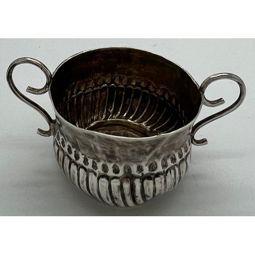 592 - A Queen Anne miniature porringer 4cm d x 3cm h with spiral fluting and wirework handles, London 1707... 