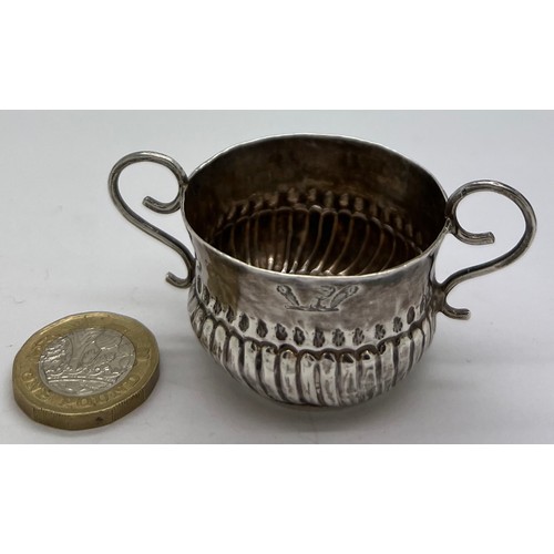 592 - A Queen Anne miniature porringer 4cm d x 3cm h with spiral fluting and wirework handles, London 1707... 