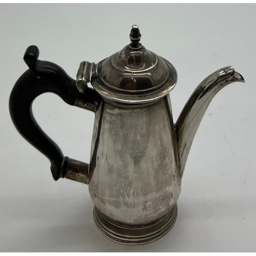 595 - Miniature silver coffee pot circa 1740, maker J.S. 7cm h with ebony handle.