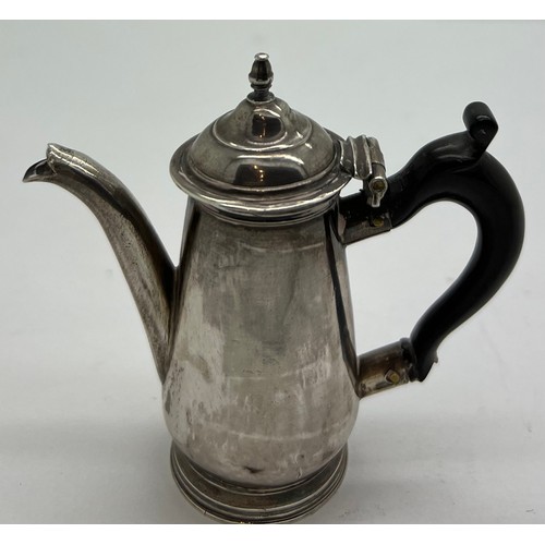 595 - Miniature silver coffee pot circa 1740, maker J.S. 7cm h with ebony handle.